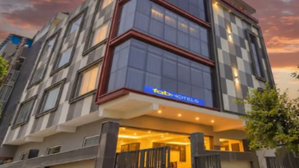 A modern hotel building with a checkered facade and large windows. - FabHotel Royal 116 (Noida)