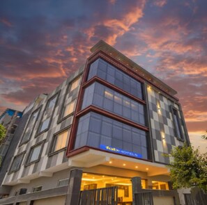 A modern hotel building with a checkered facade and large windows. - FabHotel Royal 116 (Noida)