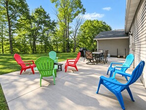 A patio with outdoor furniture, a grill, and a covered area.