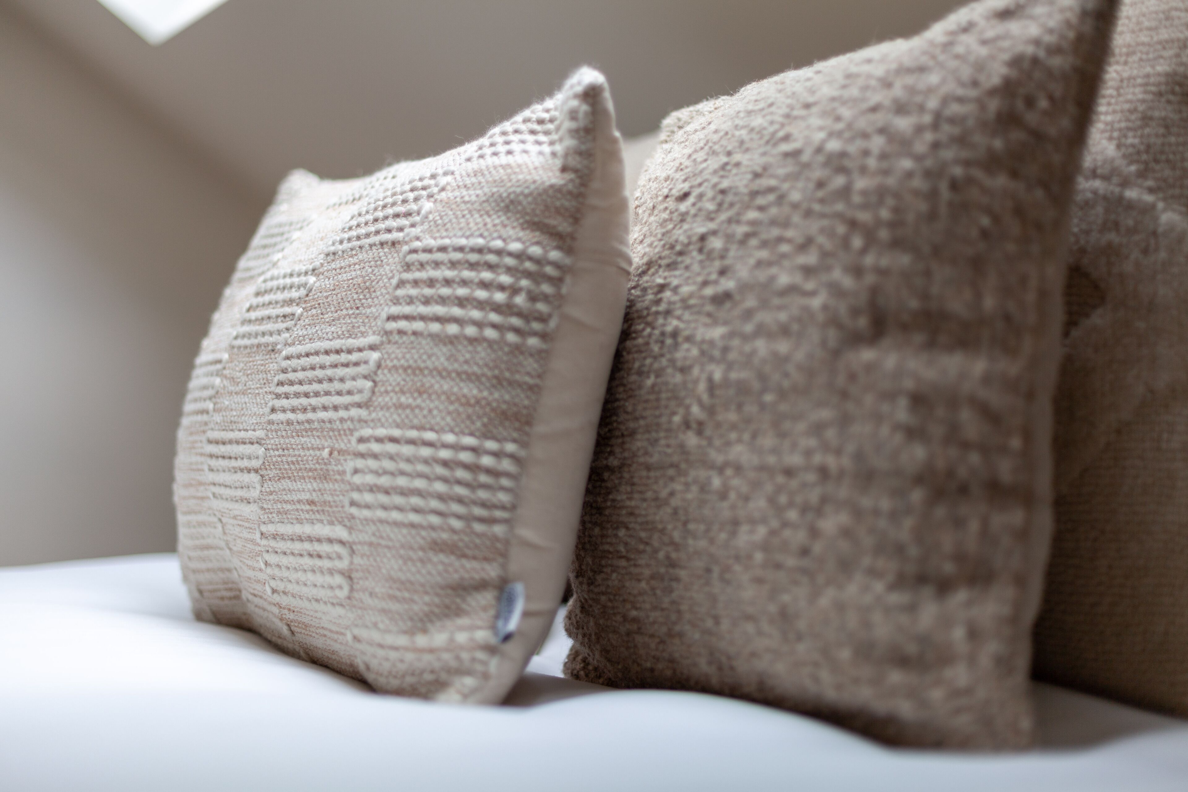 A close-up of two pillows on a bed.