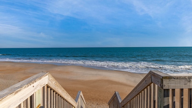 A wooden boardwalk leading to a beach with clear skies. - Dolphin's Den | Ocean Views + Community Pools (North Topsail Beach)
