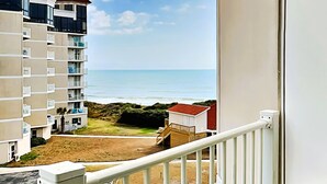 A balcony with a view of a beach and ocean. - Dolphin's Den | Ocean Views + Community Pools (North Topsail Beach)