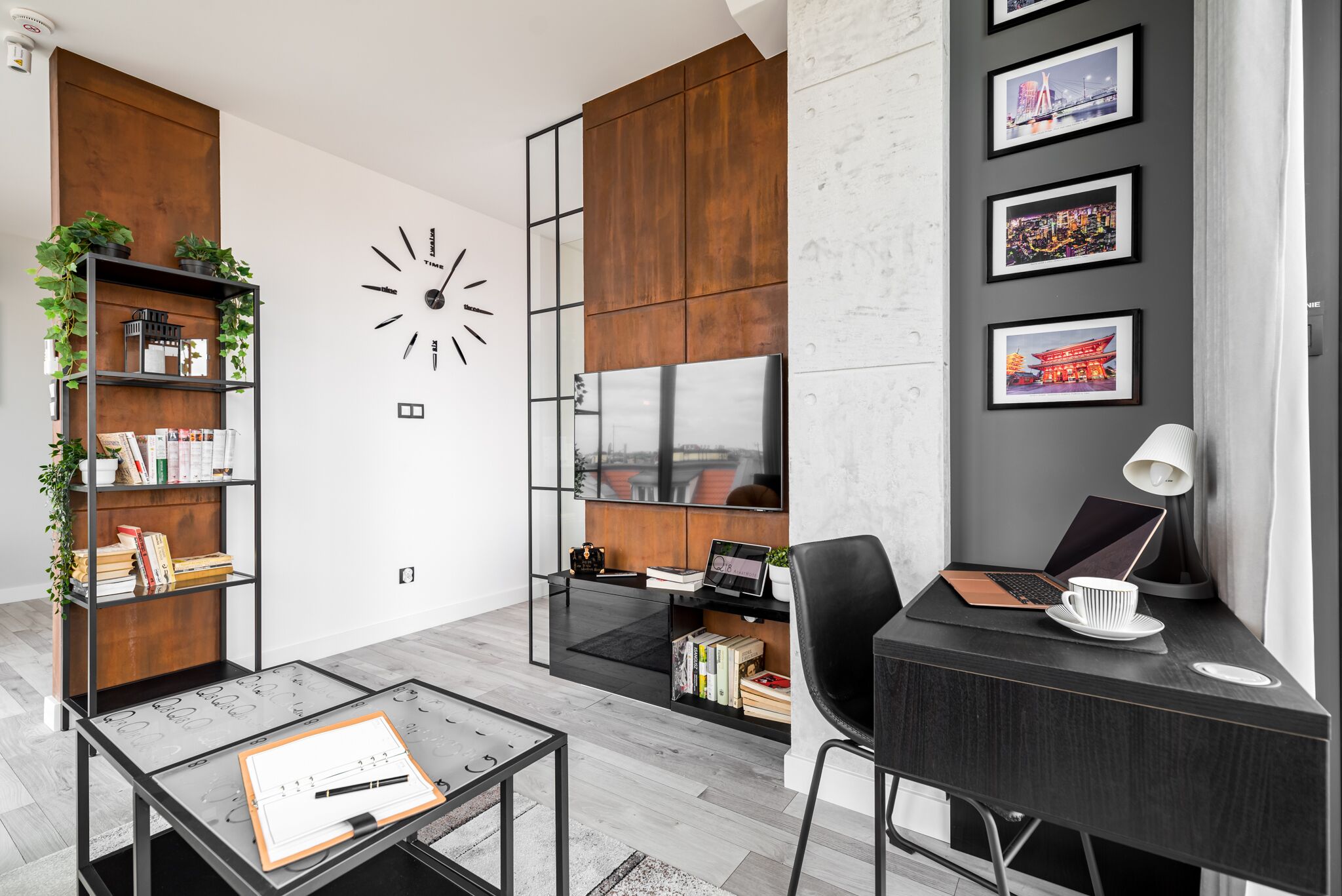 A modern office space with a desk, chair, bookshelf, and a wall clock.
