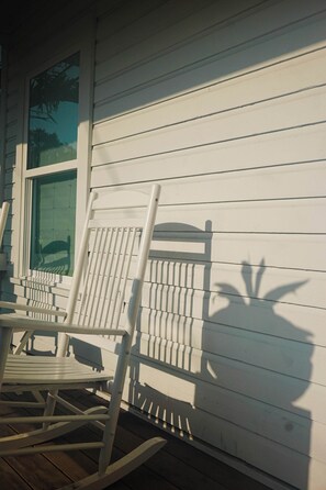A white wooden deck with a rocking chair and a table. - Otis Blue at Angels Quarter | Home Steps to 7th! (Tampa)