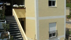 A two-story building with a staircase leading to the entrance. - Sea Hedgehog Studio (Ponza)