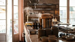 Una cocina con una estufa grande, ollas y un vaporizador.