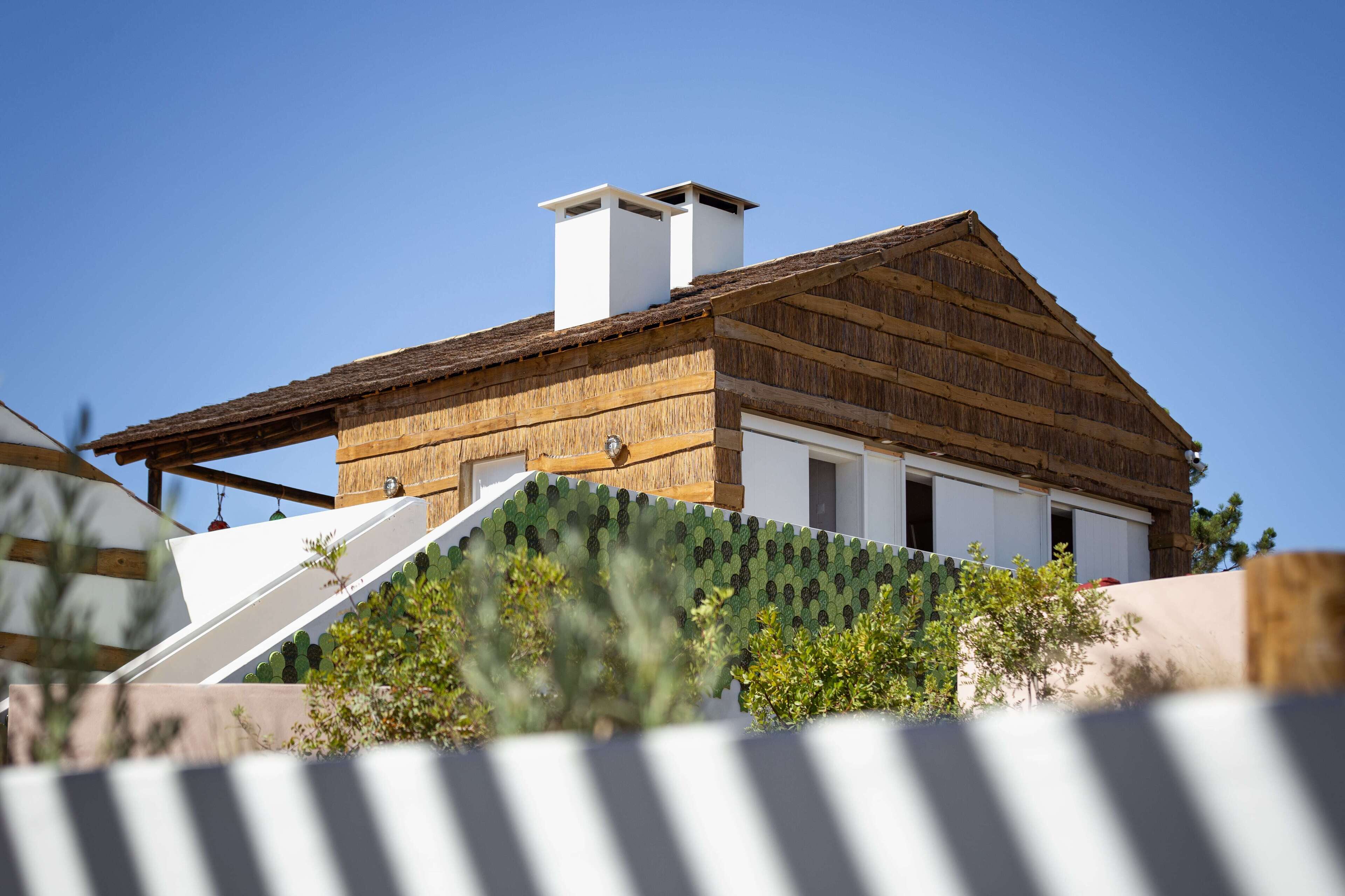 A modern building with a sloped roof and a chimney.
