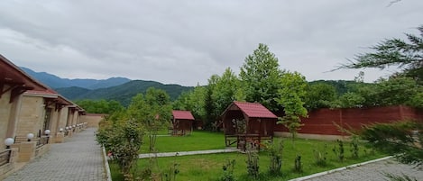 Stroll through our serene courtyard, surrounded by lush greenery and majestic mountains.