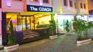 A multi-story hotel with a sign reading "The Coach" at the ground level. - THE COACH HOTEL (Istanbul)