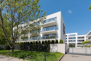 Stylish building with a flat roof, large windows, and a well-manicured lawn.