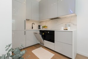 Enjoy cooking in this well-equipped kitchen with a dishwasher, oven, and coffee maker.