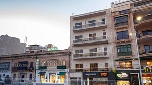 A street view with a Rolex store, a sushi restaurant, and a Dr. Juice store. - Remarkable 2-bed Apartment in St Julians (St. Julian's)