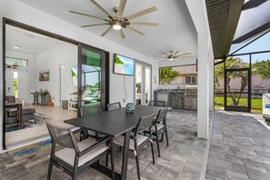 Enjoy dining al fresco in this outdoor space with a table and chairs, surrounded by a residential view.