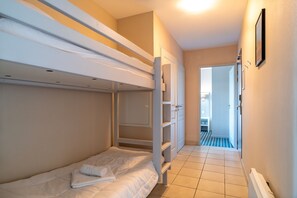 Cozy sleeping space for two, featuring a bunk bed arrangement and essential amenities.