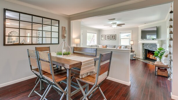 A dining area with a wooden table and chairs, a fireplace, and a view into another room. - Canyon Lake Vacation Rental < 1/2 Mi to Water! (Canyon Lake)