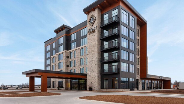 A multi-story hotel with a prominent 'Legacy Hotel' sign, large windows, and a modern architectural design. - Legacy Hotel Trademark Collection By Wyndham (Green Bay)