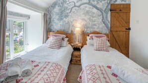 A bedroom with two beds, a large window, and a tree mural on the wall. - 2 bedroom accommodation in Eyam, near Bakewell (Eyam, near Bakewell)