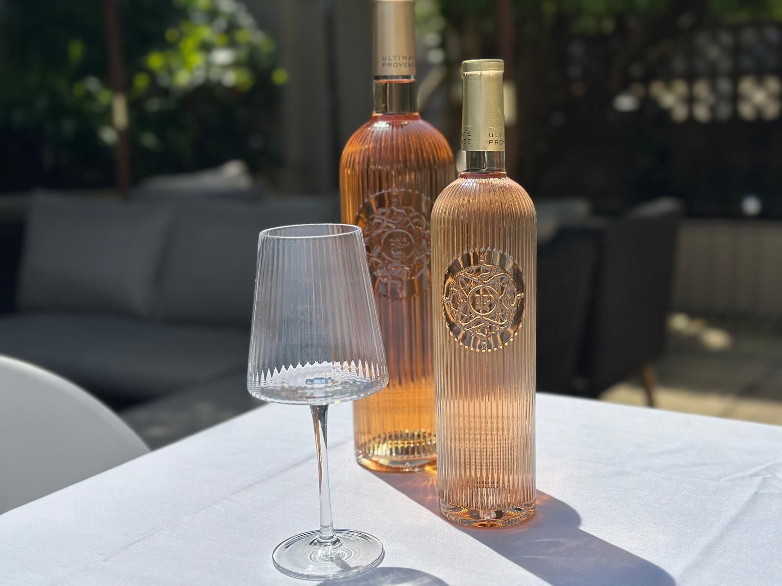 A table with a wine bottle and a wine glass.