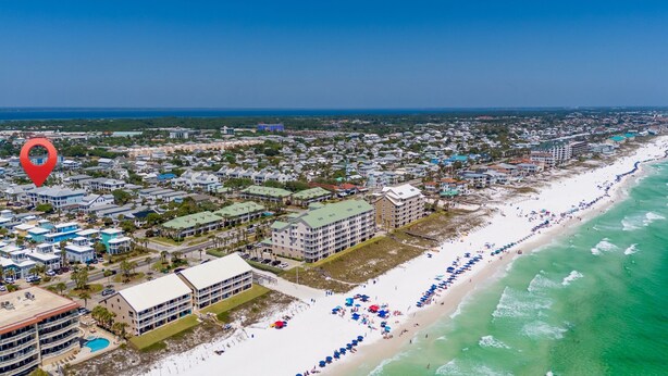 An aerial view of a coastal town with a beachfront, hotels, and a clear blue sky. - Home & Cabana House | Pool | Steps to the Beach! (Destin)
