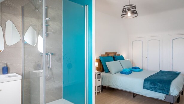 Un dormitorio con cama, mesitas de noche y ducha.
