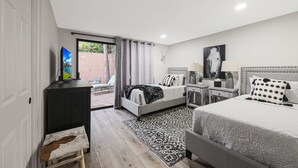 A modern bedroom with a bed, bedside tables, a desk, and a television. - Quiet & Close to Everything in Scottsdale, Arizona (Scottsdale)