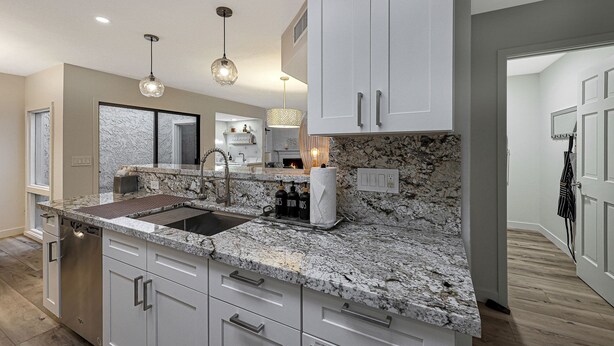 A modern kitchen with granite countertops, stainless steel appliances, and pendant lighting. - Quiet & Close to Everything in Scottsdale, Arizona (Scottsdale)