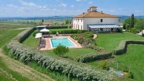 A large house with a swimming pool, surrounded by well-maintained gardens and a view of the countryside. - Villa Mimi - Nine Bedroom Villa, Sleeps 18 (Castroncello)