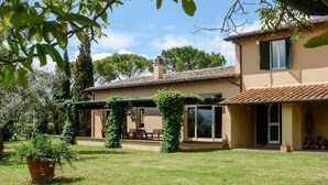 A two-story house with a covered patio, a chimney, and a garden with a potted plant. - Villa Faruffini - Four Bedroom Villa, Sleeps 8 (Magliano Sabina)