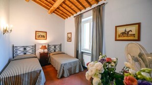 A bedroom with two beds, a wooden ceiling, a window with curtains, and a fan. - Villa Faruffini - Four Bedroom Villa, Sleeps 8 (Magliano Sabina)