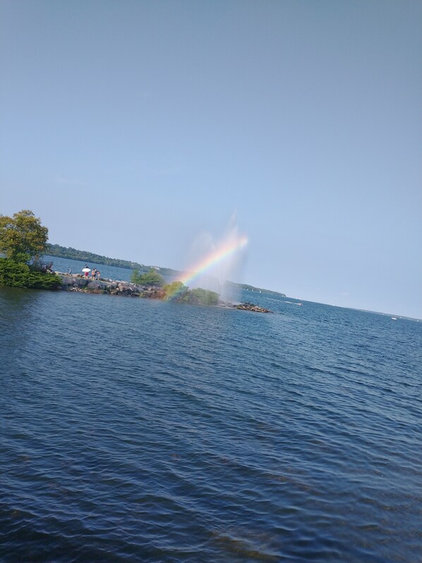A lake with a rainbow over a rocky island. - Vacation Home in Barrie (Barrie)