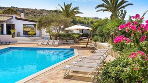 A swimming pool with lounge chairs, a patio area, and a view of a hillside. - Camilla Canna - Three Bedroom Villa, Sleeps 6 (Cala Rossa)