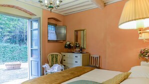 A bedroom with a bed, a dresser, a chair, and a window with an open door. - Dimora Dayan - Nine Bedroom Villa, Sleeps 18 (Capannori)