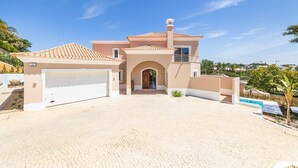 A two-story house with a tiled roof, a garage, and a paved driveway. - Villa Catao - Four Bedroom Villa, Sleeps 8 (Almansil)
