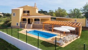 A two-story yellow house with a swimming pool, outdoor seating, and a pergola. - Villa Botela - Three Bedroom Villa, Sleeps 6 (Lagoa)