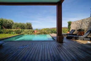 An infinity pool, a heated pool, sun loungers