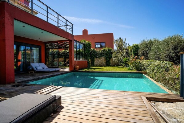 An infinity pool, a heated pool, sun loungers