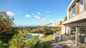 A modern house with a pool, outdoor seating, and a view of the landscape. - Villa Esqueiro - Three Bedroom Villa, Sleeps 6 (Moledo)
