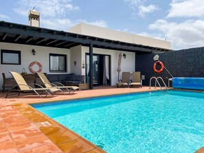 A heated pool, pool loungers