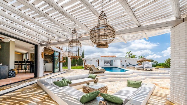 A covered outdoor lounge area with a pool, white furniture, and hanging wicker lamps. - Villa Adaline - Five Bedroom Villa, Sleeps 10 (Alcaucín)