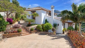 A white villa with a tiled roof, a stone staircase, and a paved courtyard. - Villa Loli - Three Bedroom Villa, Sleeps 6 (Frigiliana)