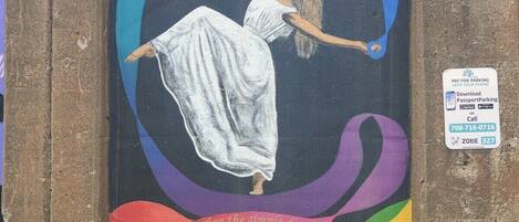 A mural of a woman in a white dress with a quote by Doris Humphrey.
