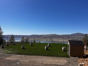 Enjoy serene views of a tranquil lake and rolling hills from this peaceful outdoor space.
