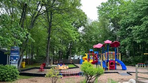A playground with colorful play structures and a sign indicating community rules. - Entire house on quiet street w/fenced yard—1 block from river, 3 from bay (Annapolis)