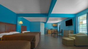 A hotel room with two beds, a desk, a chair, and a television. - Plaza Motel Corpus Christi By Oyo (Corpus Christi)