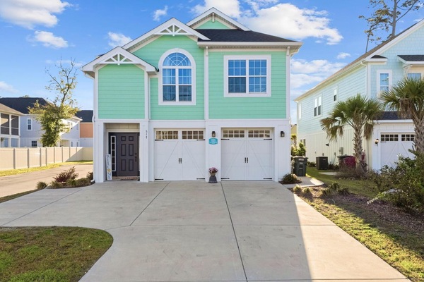 Bright coastal home with spacious driveway and garage