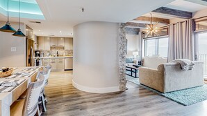 A modern interior with a dining area, kitchen, and living space. - Wilderness retreat with pool, hot tub, and sauna access - wood-burning fireplace (Sugar Mountain)