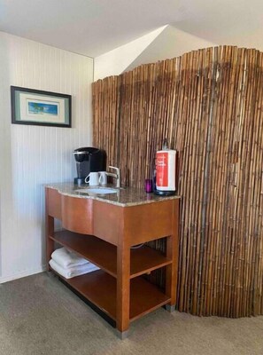 Cozy retreat with a wooden table, coffee maker, and comfortable amenities.