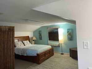 Cozy retreat with a wooden bed, floor lamp, and mirror.