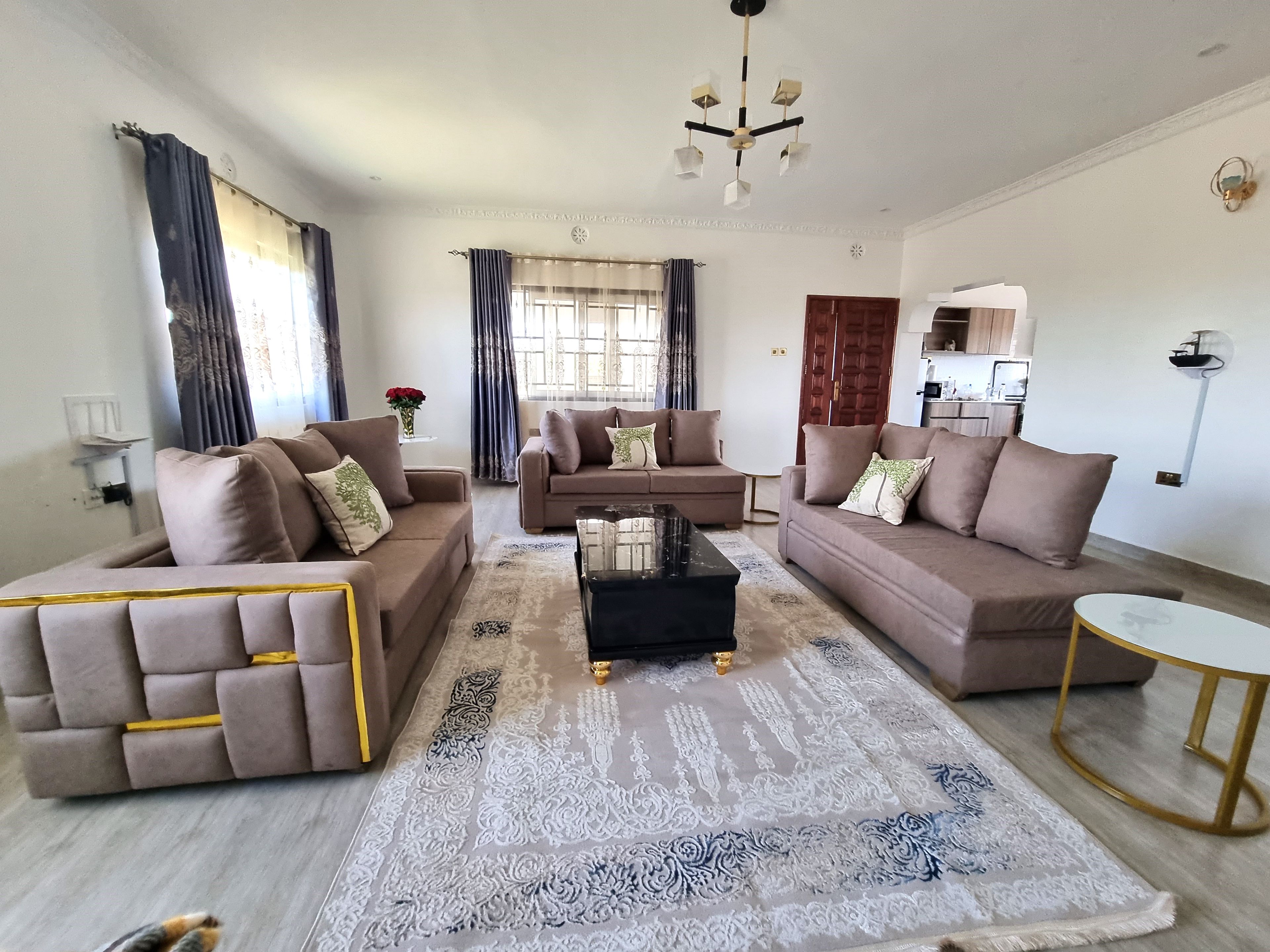 A modern living room with two sofas, a coffee table, and a rug.