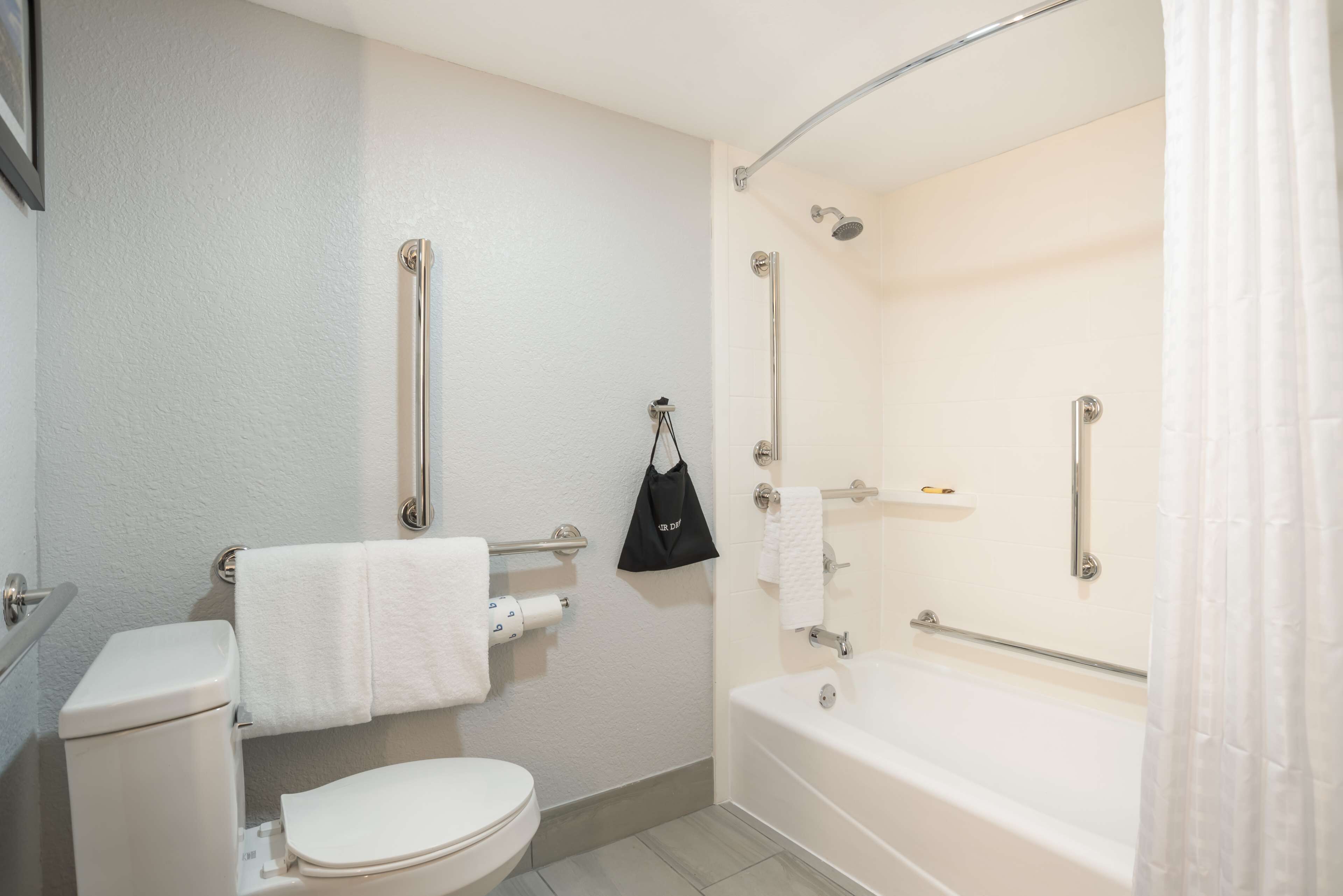 A bathroom with a toilet, a sink, a bathtub, and a shower.